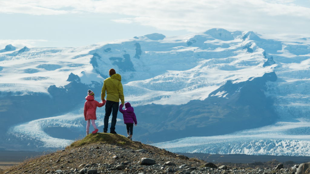 Father and two children admiring the snowy scenery in Iceland