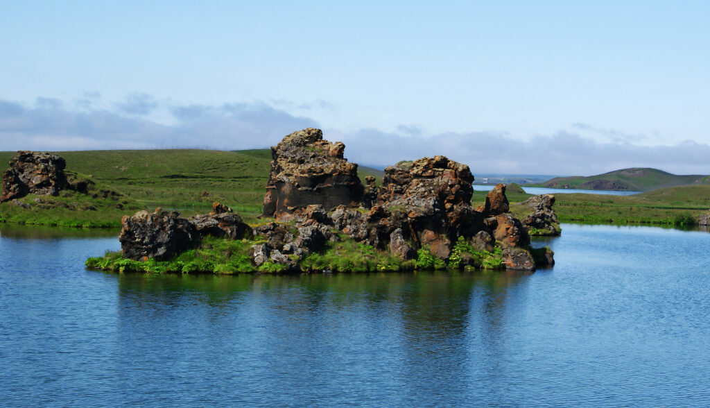 Lake Mývatn in the North of Iceland with a little rocky island in the middle.